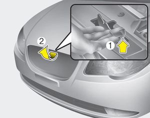 2. Go to the front of the vehicle, raise the hood slightly, pull the secondary