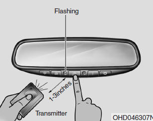 2. Press and hold the button on the HomeLink system you wish to train and the