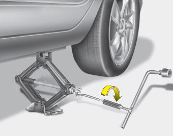 8. Insert the jack handle into the jack and turn it clockwise, raising the vehicle