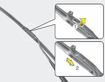 2. Lift up the wiper blade clip. Then pull down the blade assembly and remove